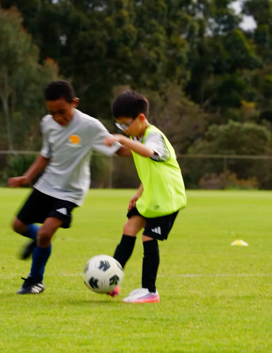 Two players contesting the ball during a training drill